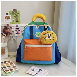 Detail of color-block kids backpack with cute lion pouch and functional pockets
