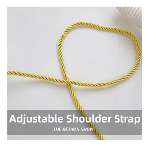 Close-up of golden twisted silk shoulder strap showing fine texture and adjustable design