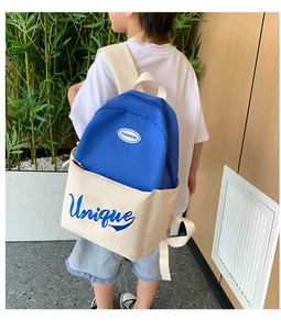 Side view of student wearing the bicolor canvas backpack with Unique lettering print