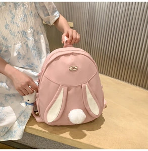 Pink rabbit backpack for girls featuring white long ears and a plush pompom tail detail