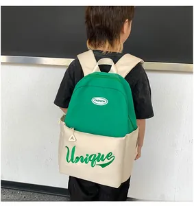 Side view of large capacity school backpack with fashion letter embroidery for students