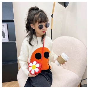 Close-up of a red flower-shaped crossbody bag with a white knit sweater for children
