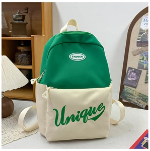 Close-up of green and white canvas backpack with Fashion and Unique lettering details