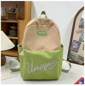 Close-up of dual-tone green school backpack with Unique embroidery on a study desk