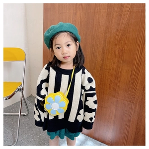Close-up of bright yellow sunflower crossbody bag with a cute knit floral sweater for kids