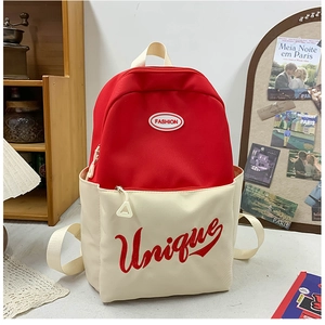 Detail of red and cream contrast school backpack with circular Fashion logo and side pockets