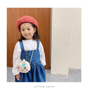 Detailed close-up of the cute white rabbit crossbody bag worn by a young girl