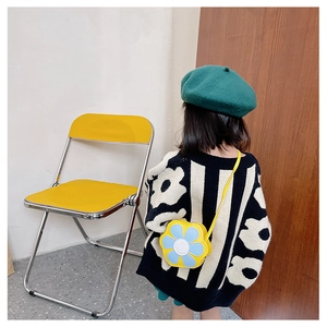 Detail of yellow sunflower shaped crossbody bag paired with floral knit sweater for kids