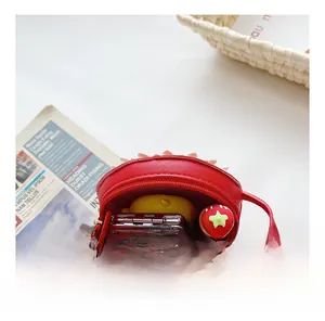 Detail view showing interior capacity and zipper of the red mini round kids' bag