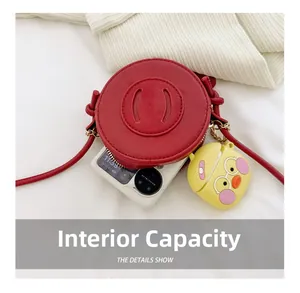 Interior capacity of red round mini bag holding a foldable phone and earbud case