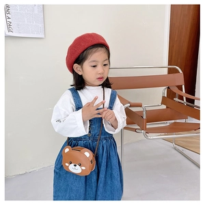 Detail of cute brown bear-shaped PU leather crossbody bag for kids with 3D ears