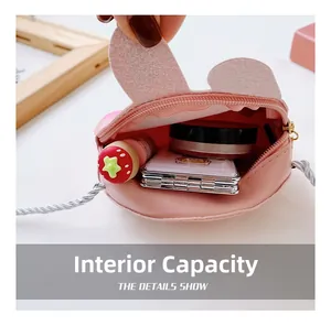 Internal storage capacity of a pink rabbit shoulder bag for children showing mini items