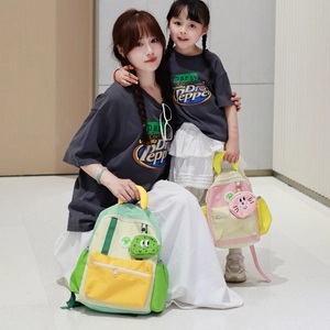 Children's color-block backpacks in green and pink with cute cartoon pendant charms