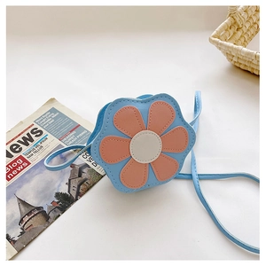 Detail of a mini floral shoulder bag for kids in light blue and pink faux leather