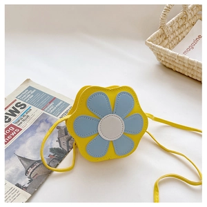 Macro shot of yellow flower shaped mini crossbody bag for kids with blue petal accents