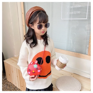 Toddler girl wearing a red cartoon rabbit crossbody bag with floral detail and cute ears