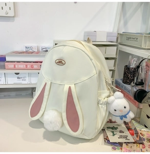 Detail of cute bunny backpack with plush tail decoration and rabbit charm accessory