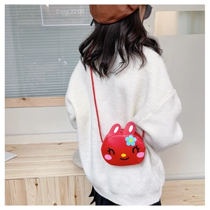 Rear view of a child wearing a cute red bunny crossbody bag with floral embroidery