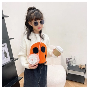 Detail of pink 3D daisy flower round crossbody bag styled with girl's casual outfit