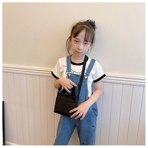 Girl wearing black canvas crossbody bag with adjustable strap and dual handles
