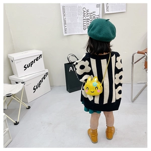 Detail of yellow rabbit cartoon kids shoulder bag with chain strap and blue flower decor