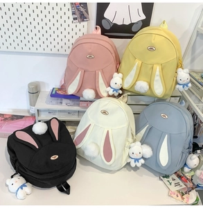 Cute rabbit backpack in multiple colors with long ears and plush ball pendant details