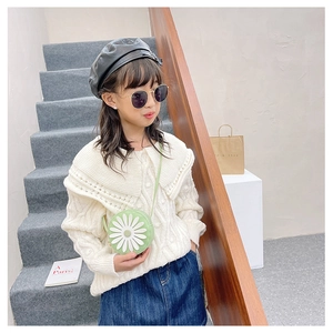 Detail of cute light green round kids crossbody bag with white daisy flower on strap