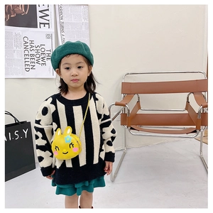 Toddler girl modeling a bright yellow 3D bunny crossbody bag with striped sweater