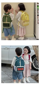 Kids backpack with THKIN letter print in green and yellow, featuring front zip pocket
