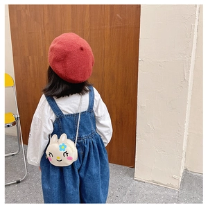 Rear view of a child wearing a cute rabbit crossbody bag with floral patterns and soft ears