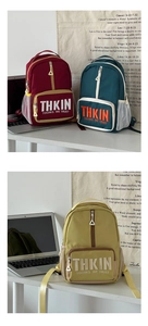 Three multi-color school backpacks with letter embroidery and white mesh side pockets