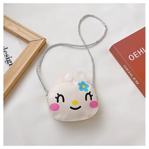 Detail of cute rabbit-shaped cream shoulder bag with floral print and silver strap