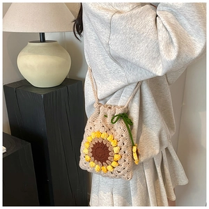 Detail of handmade crochet sunflower bucket bag with drawstring and woven texture