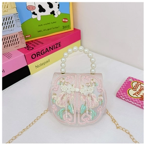 Detail of pink floral embroidery and pearl fringe on children small handbag
