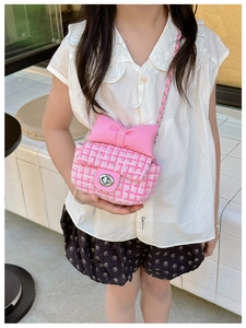 Detail of pink plaid tweed crossbody bag with bow for girls and chain strap