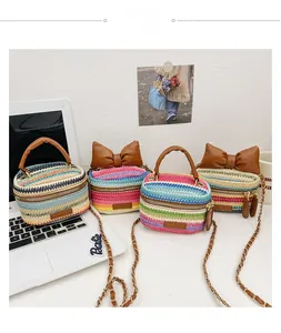 Close-up of four colorful woven straw crossbody bags with bow detail and chain straps