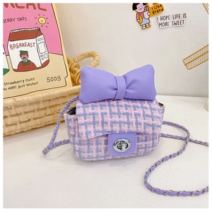 Detail of sweet purple tweed crossbody bag with bow and silver metal twist lock
