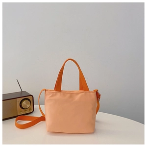 Close-up of lightweight peach nylon kids shoulder bag with shoulder strap and retro radio