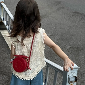 Minimalist red round leather crossbody bag for kids styled with white lace top outfit