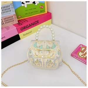 Detail of Chinese style kids bag with pearl handle and traditional embroidery