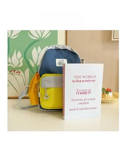 Close-up of color-block kids backpack with multiple zipper compartments and brand logo