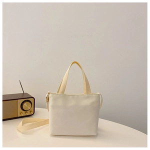 Minimalist cream canvas toddler tote bag shown with vintage radio in a clean studio setting