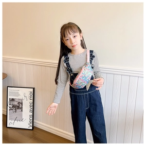 Close-up of kids' sequined waist bag with colorful fish tail design and pink strap