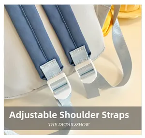 Detail showing adjustable strap with white resin buckle on a kids color-block backpack