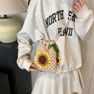 Handmade crochet sunflower crossbody bag with drawstring closure and floral knitting details