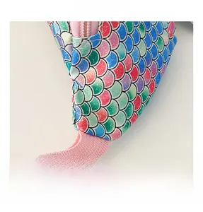Close-up of glittery gradient fish scale texture and pink zipper on kid waist bag