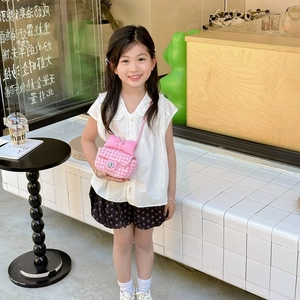Pink and white tweed girls crossbody bag featuring a large satin bow and silver metal clasp
