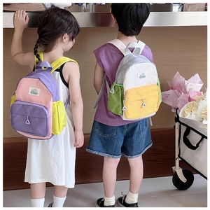 Rear view of children wearing colorful canvas backpacks with adjustable shoulder straps
