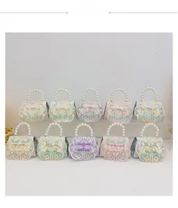 Detailed view of traditional Chinese style kids handbags with floral embroidery and pearls