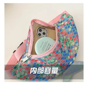 Detail view of colorful mermaid sequin waist bag interior showing storage for phone and powder